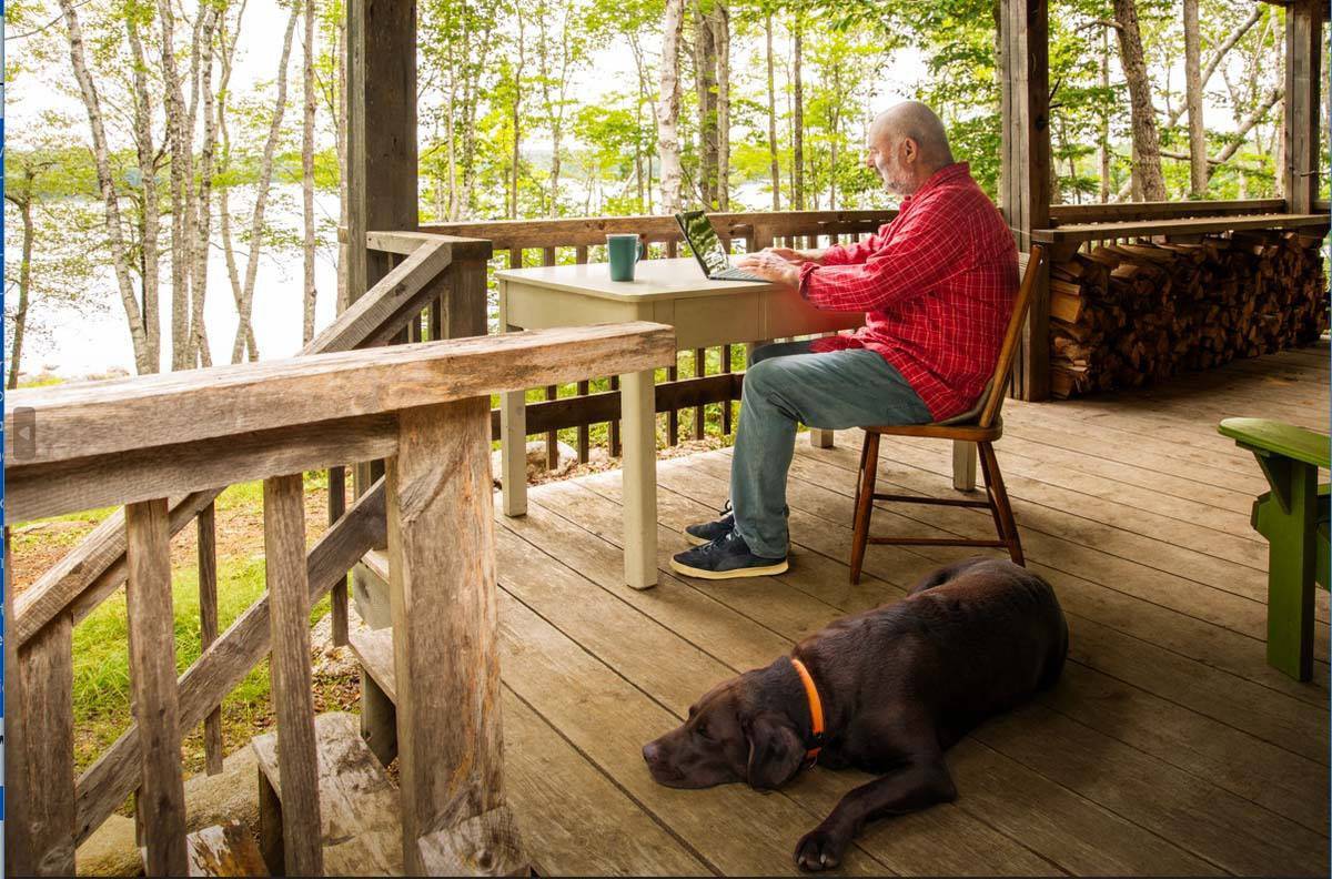 man sitting on porch with dog